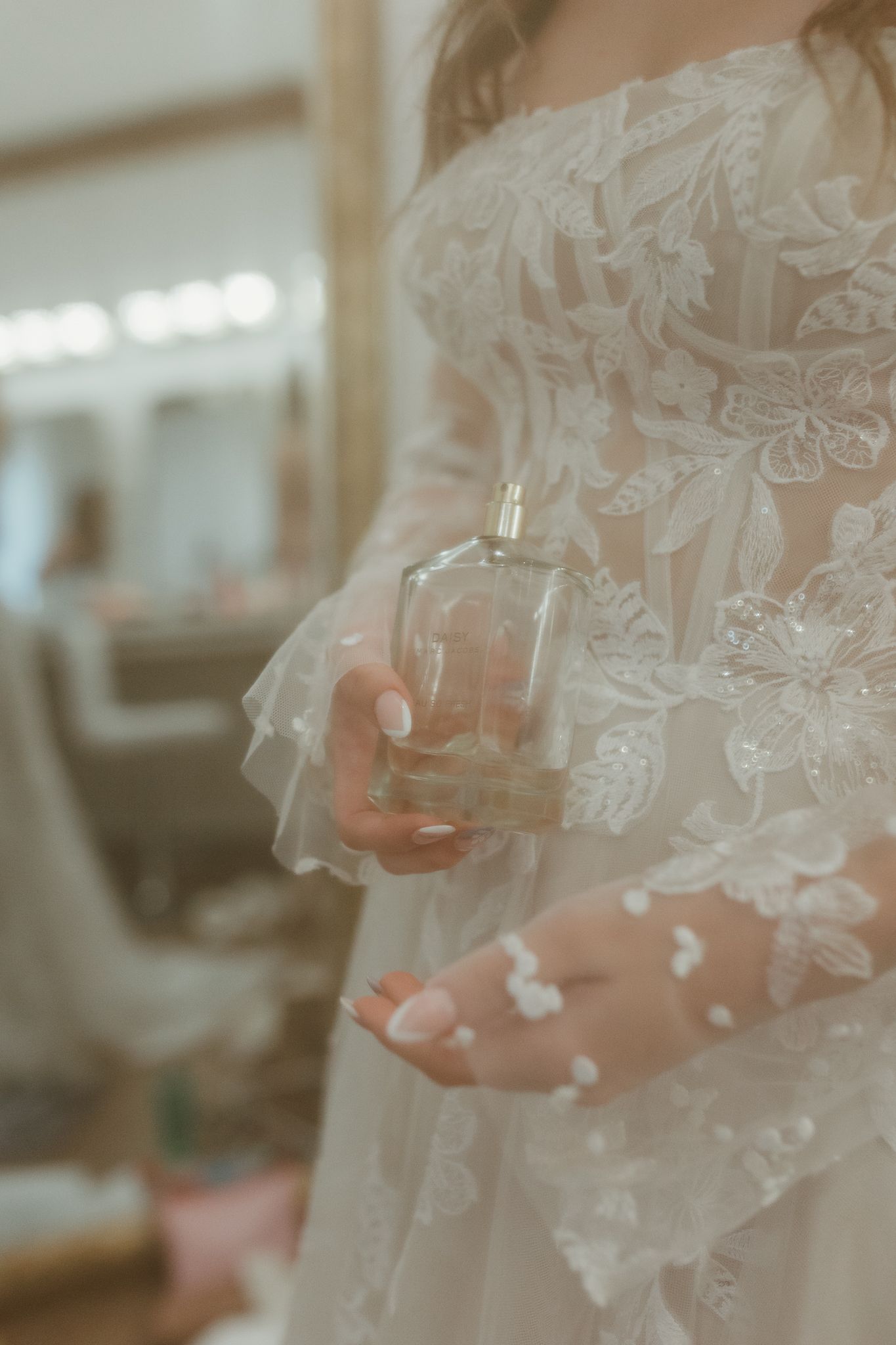 Close-up detail of delicate lace patterns on a white wedding dress veil.