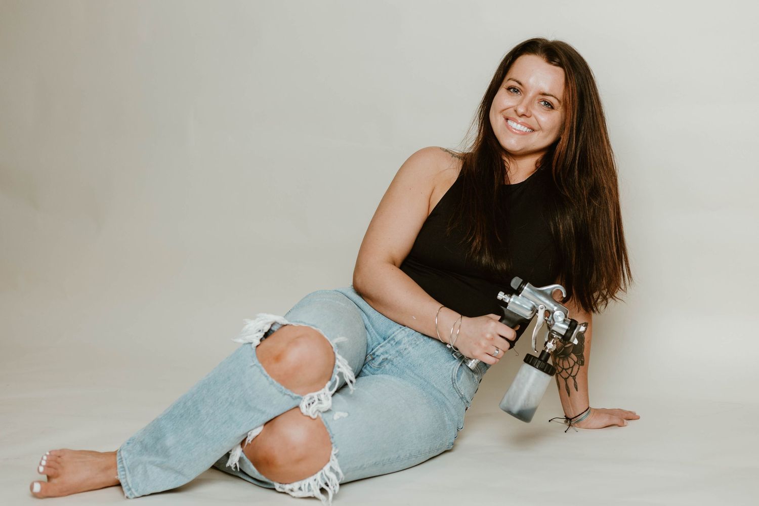 Casual lifestyle photos showing someone in ripped jeans posing with vintage photography equipment.