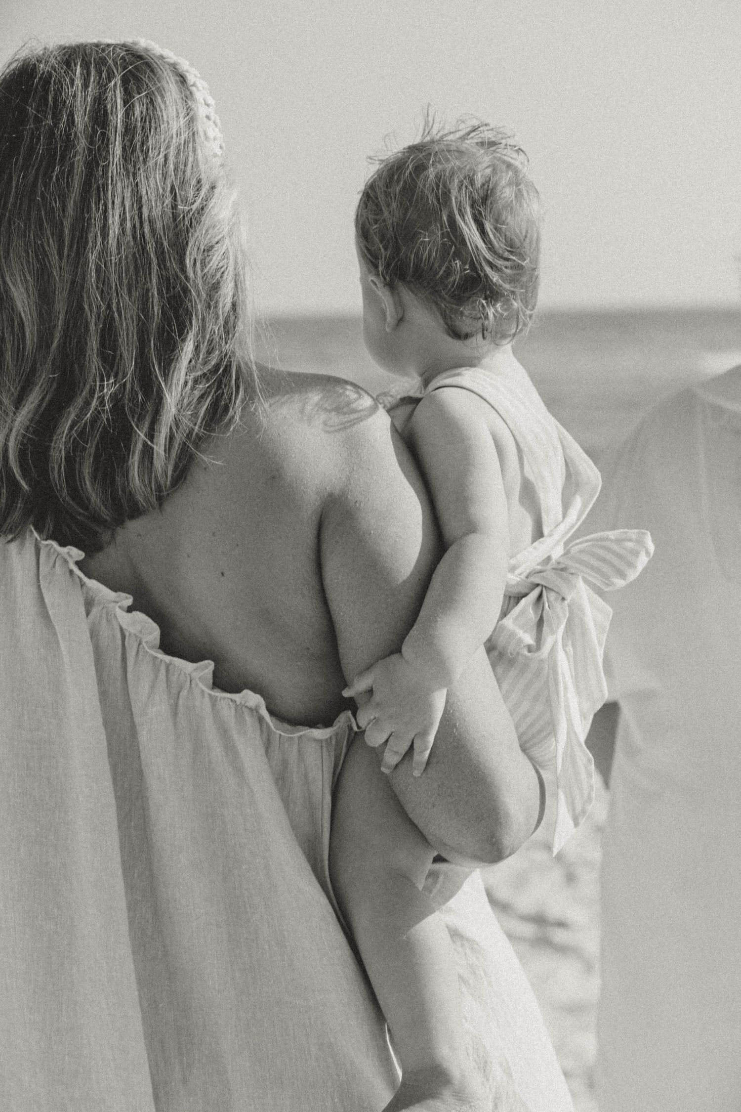 Intimate black and white portrait showing tender moments between parent and child.