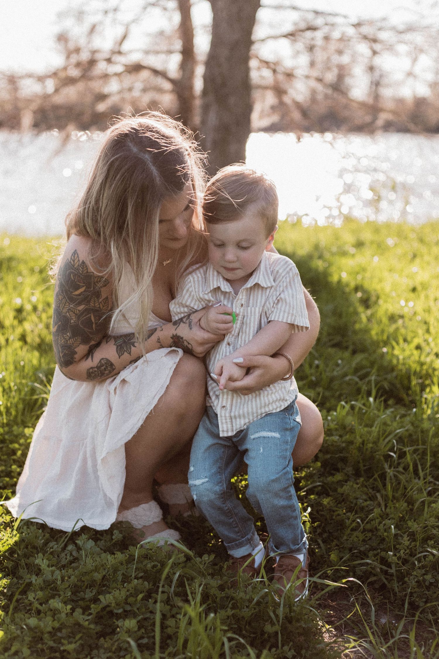 Tender moments between parent and child in a sunlit garden setting.