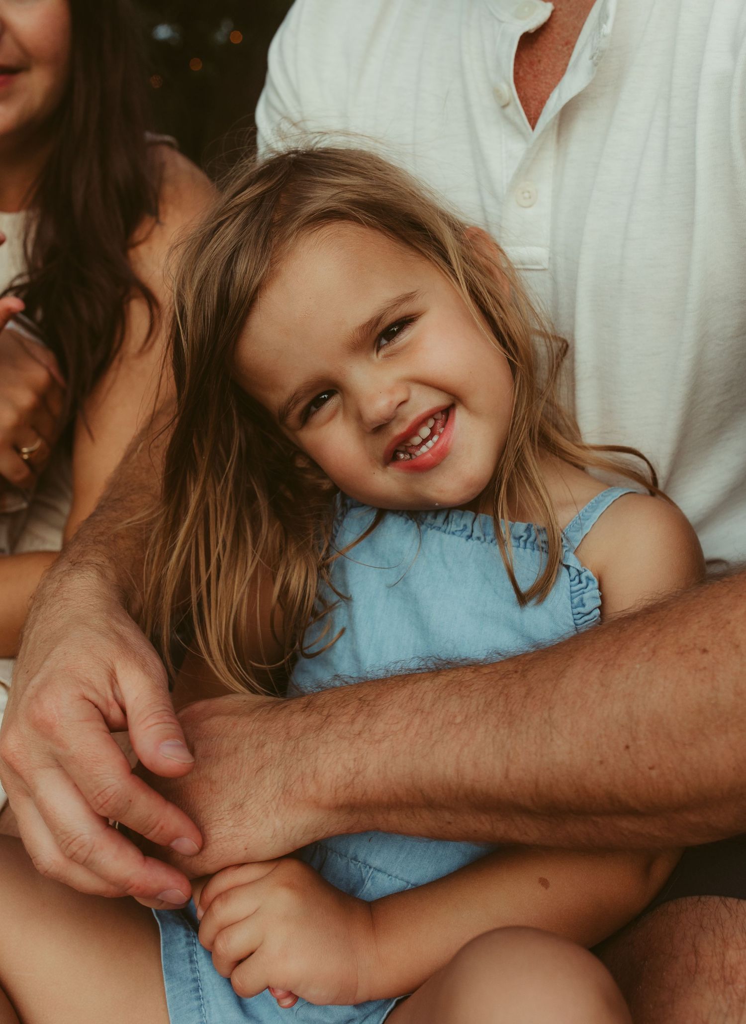 Joyful candid moments shared between family members during an outdoor photo session.