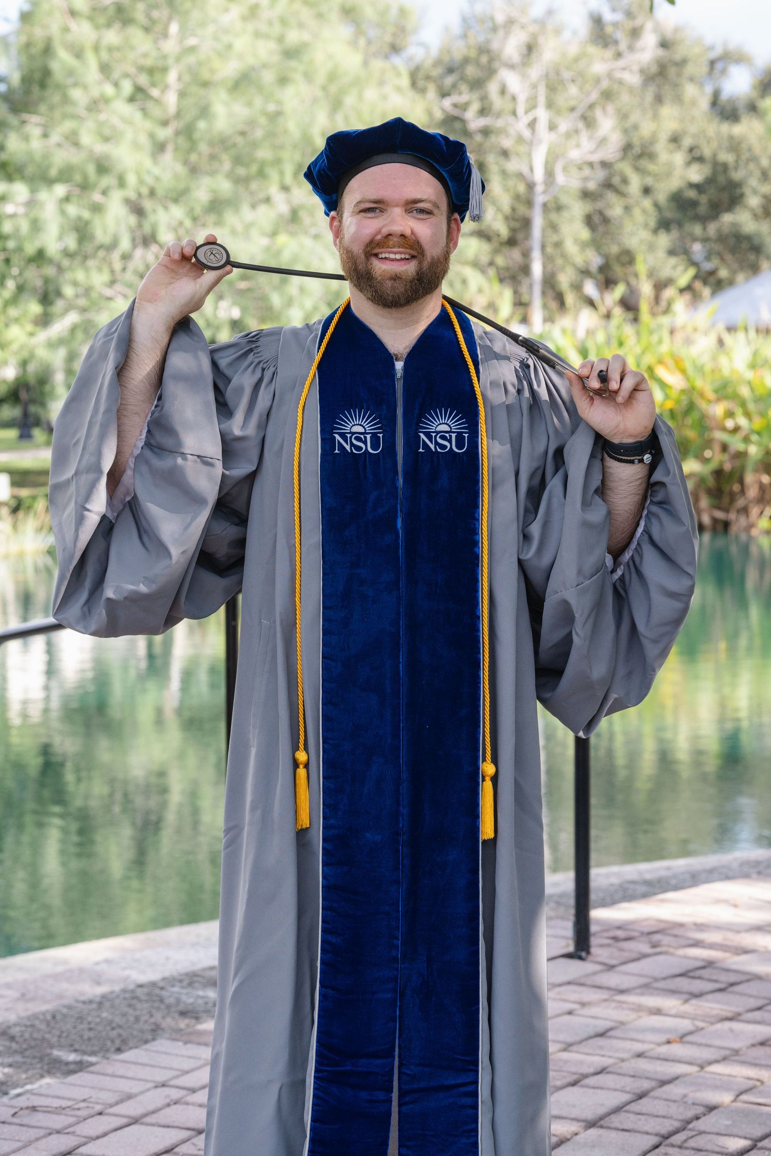 Nursing graduate photoshoot in Stuart, Florida featuring a graduate in cap and gown during a professional portrait session