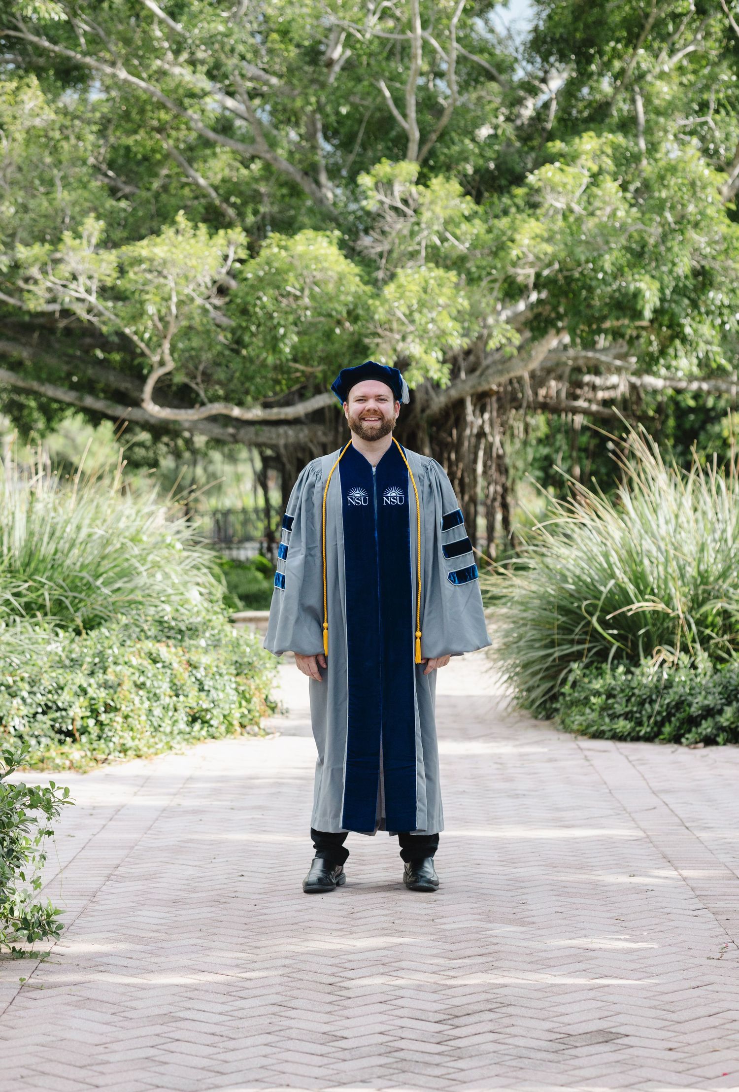 Nursing graduate photoshoot in Stuart, Florida featuring a graduate in cap and gown during a professional portrait session