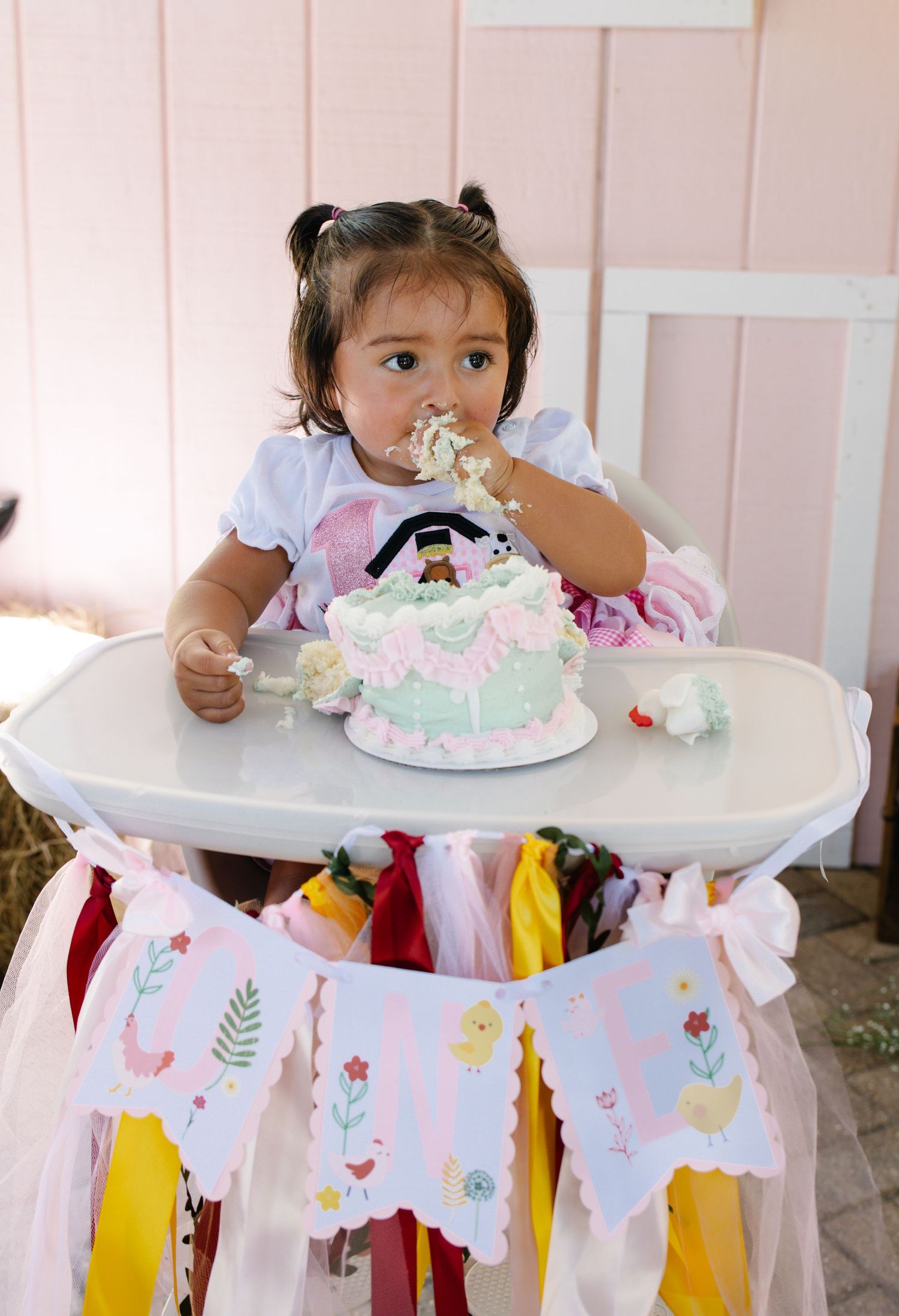 Baby girl eating her smash cake during a first birthday photography session in Okeechobee, Florida