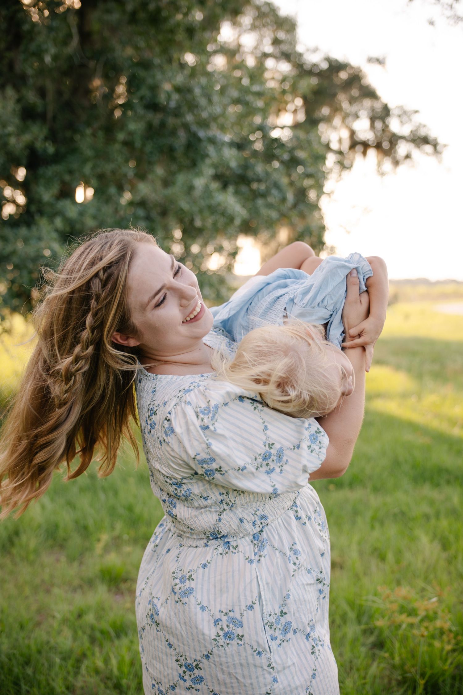 Mom and baby during a sunset motherhood portrait session in Okeechobee, Florida capturing a tender moment
