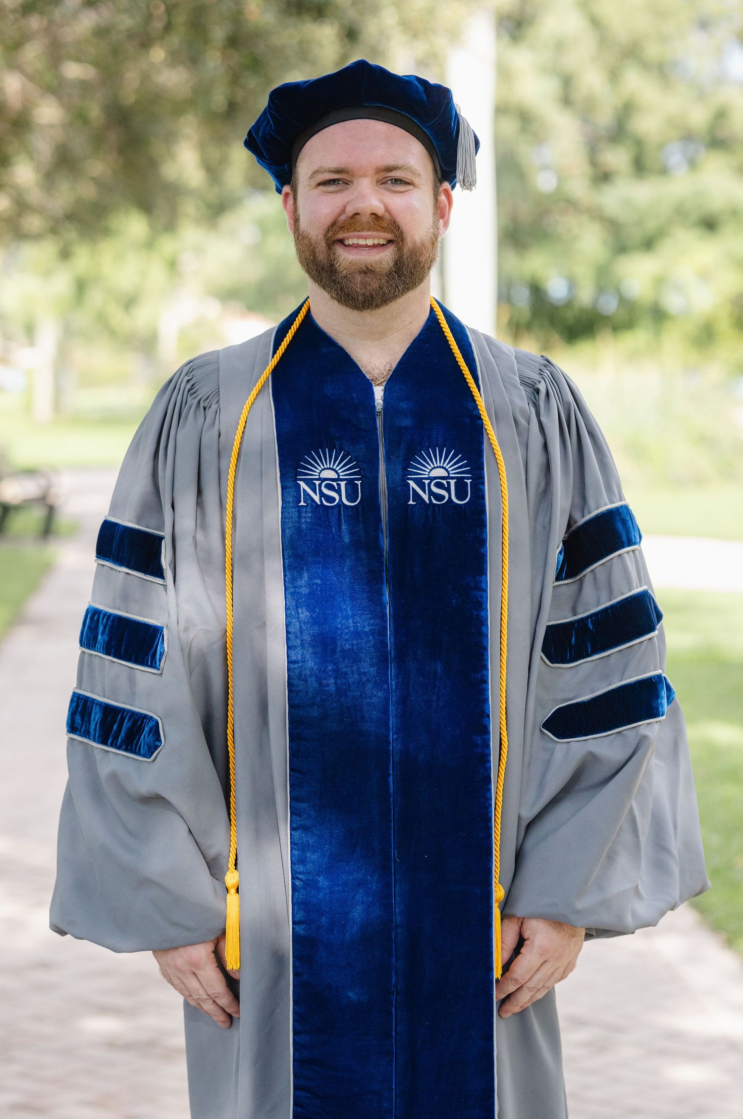 Nursing graduate photoshoot in Stuart, Florida featuring a graduate in cap and gown during a professional portrait session