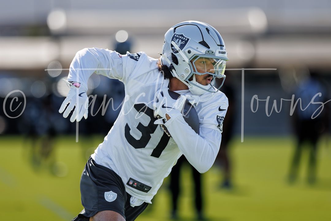 Las Vegas Raiders player #31 runs defensive back drills during outdoor training camp practice.