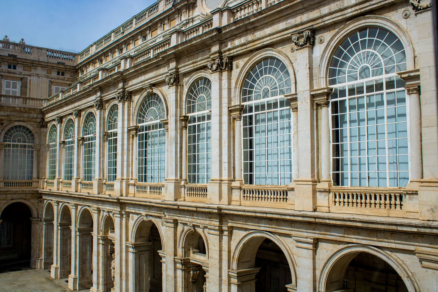 Historic building exterior featuring arched windows and classical architectural details.