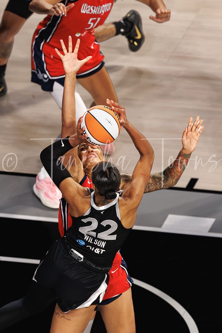 A.J. Wilson #22 of the Las Vegas Aces shoots over a Washington Mystics defender in a WNBA game.