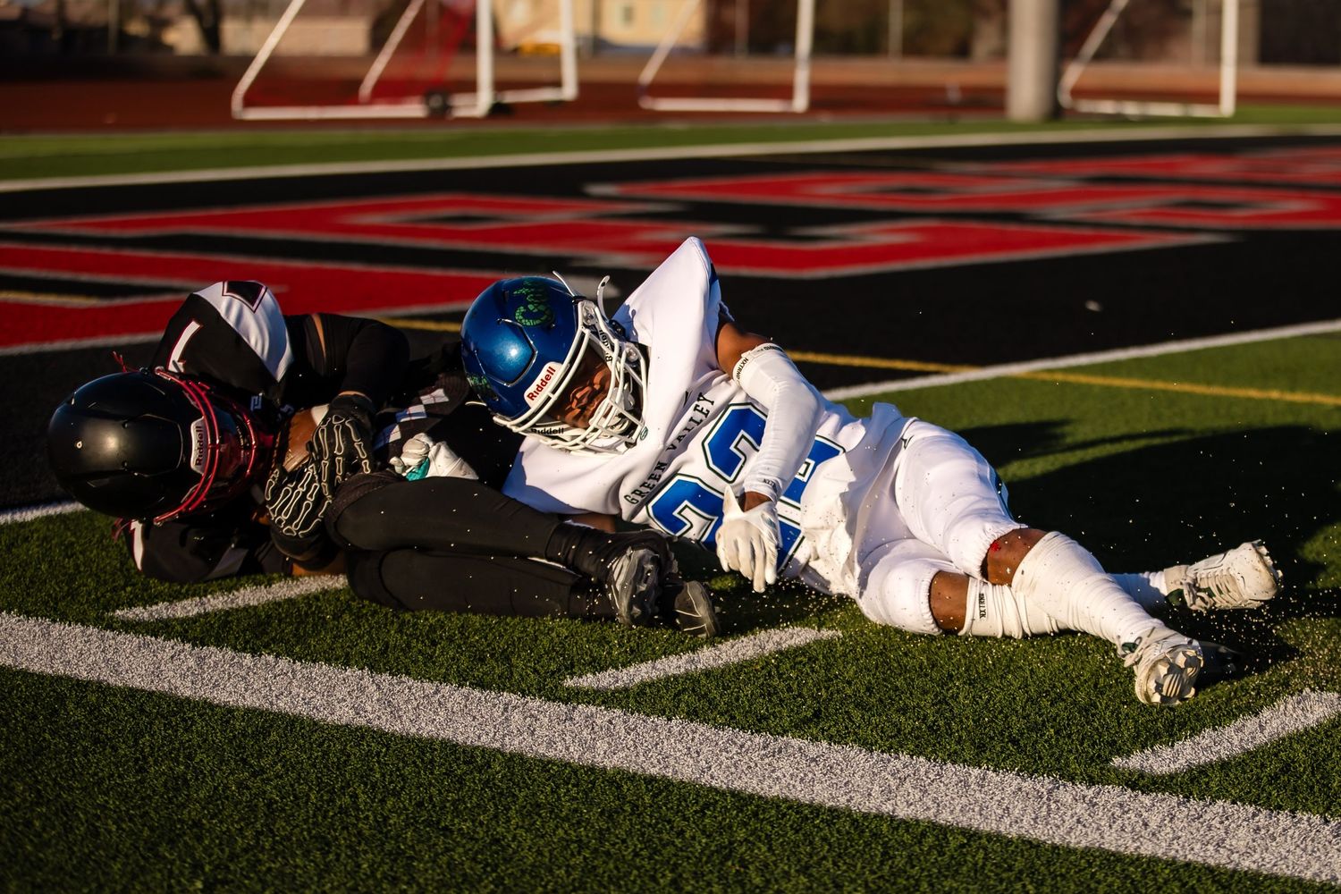 Football players lying on the field during a game or practice session.