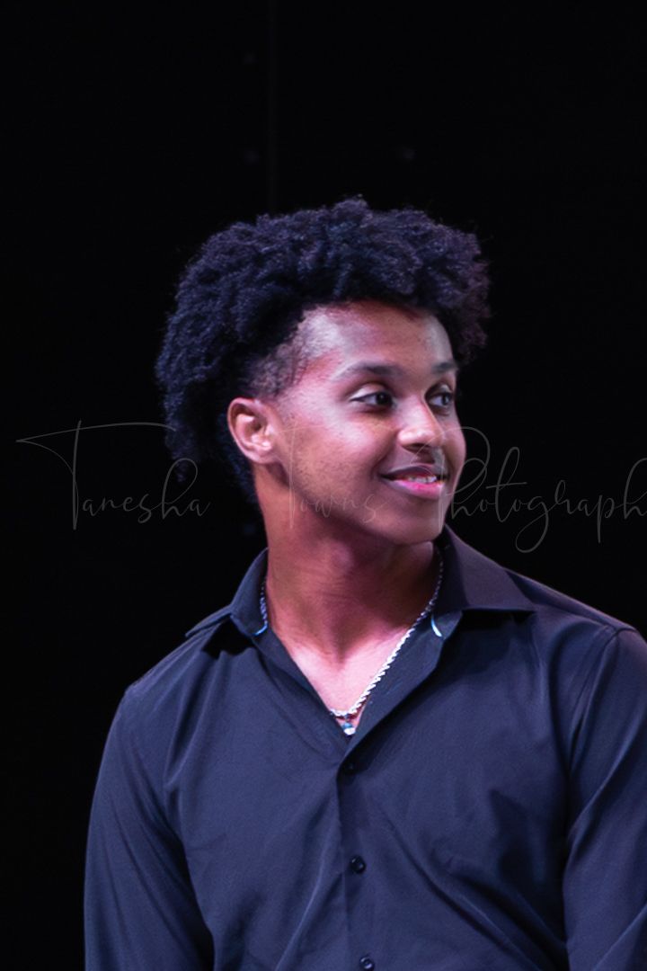 Jazz band performer in dark attire during a live musical performance.