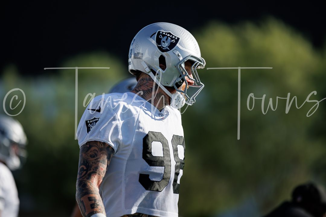 Las Vegas Raiders player #98 in white jersey yelling during NFL team practice.