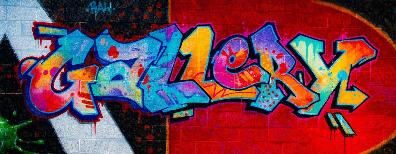 Abstract graffiti artwork featuring vibrant red and blue colors with dynamic lettering styles.