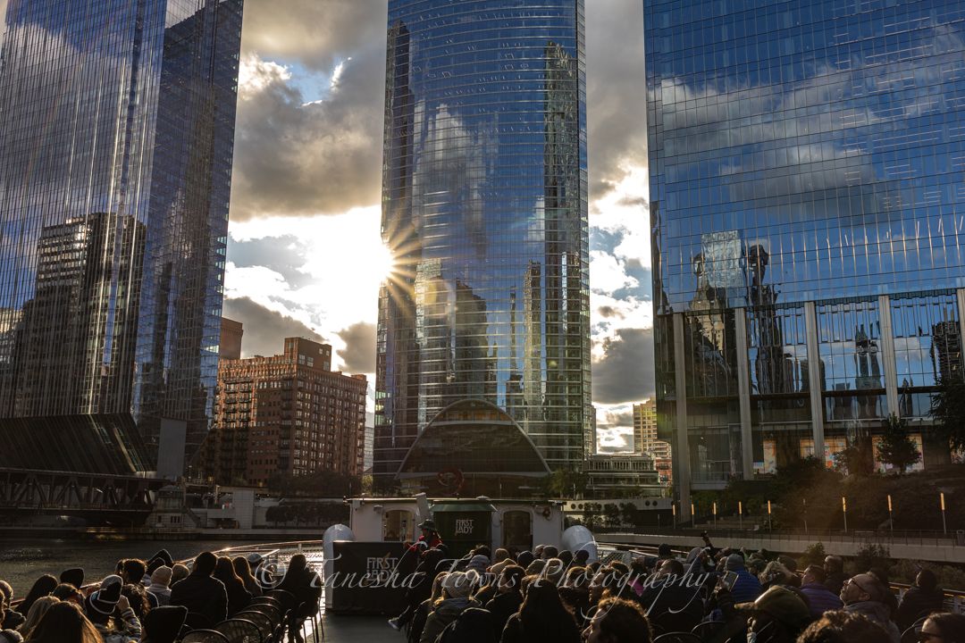 Modern glass skyscrapers reflect dramatic cloudy sky in urban cityscape panorama.