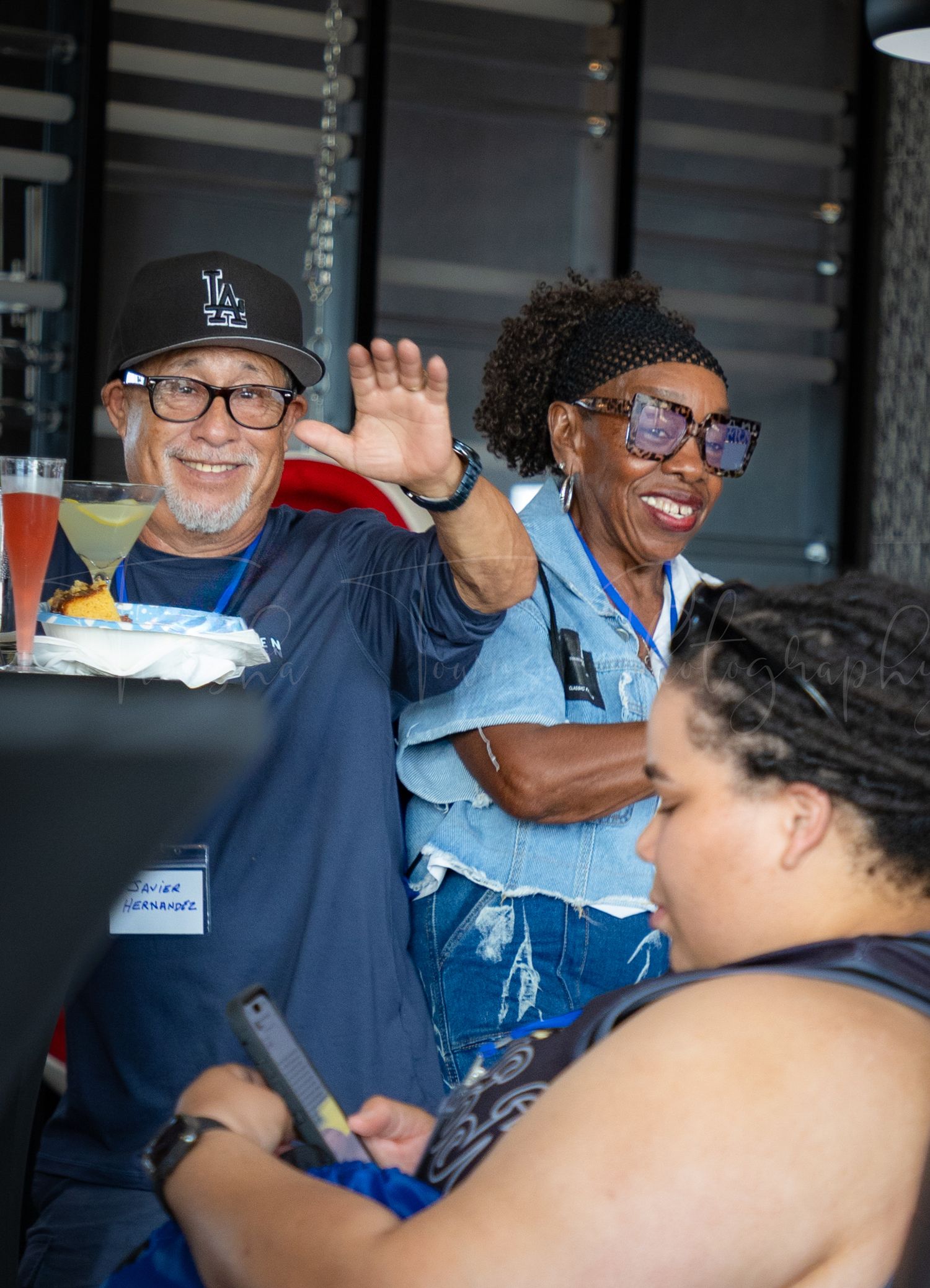 Attendees sharing a lighthearted moment during social gathering.