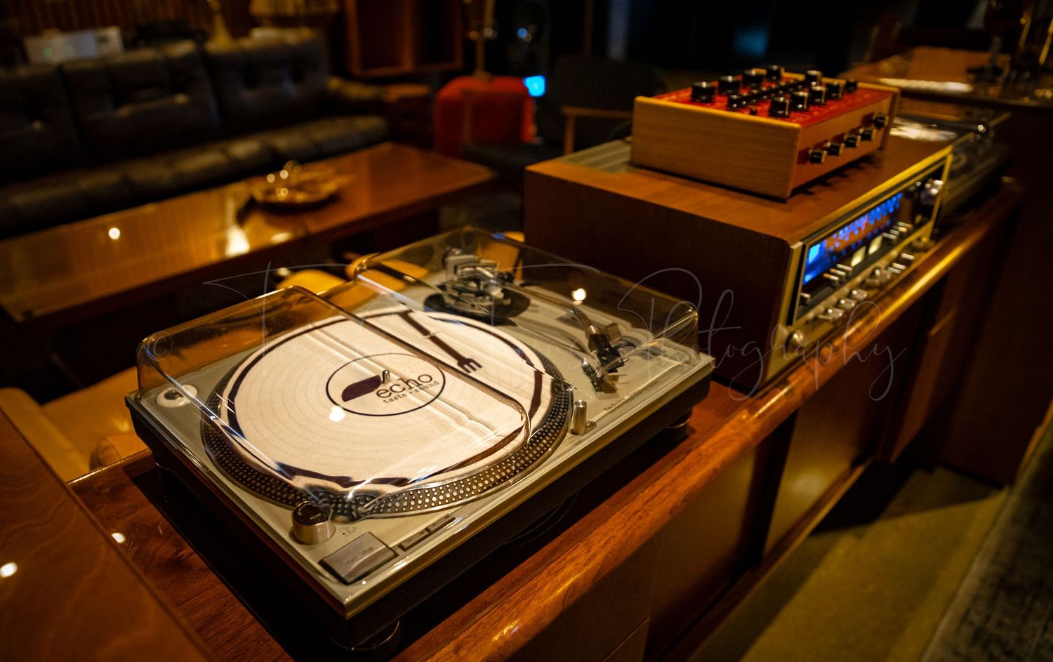 Professional DJ turntables and mixing equipment set up in a dimly lit space.