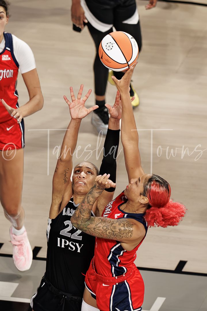 Two WNBA players battle for the ball during a Washington Mystics vs Las Vegas Aces game.