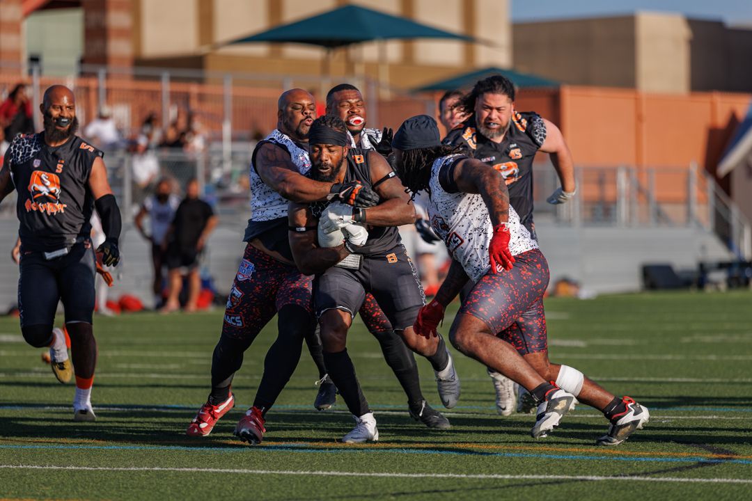 Flag football players engage in a dynamic play as teammates and opponents converge on the field.