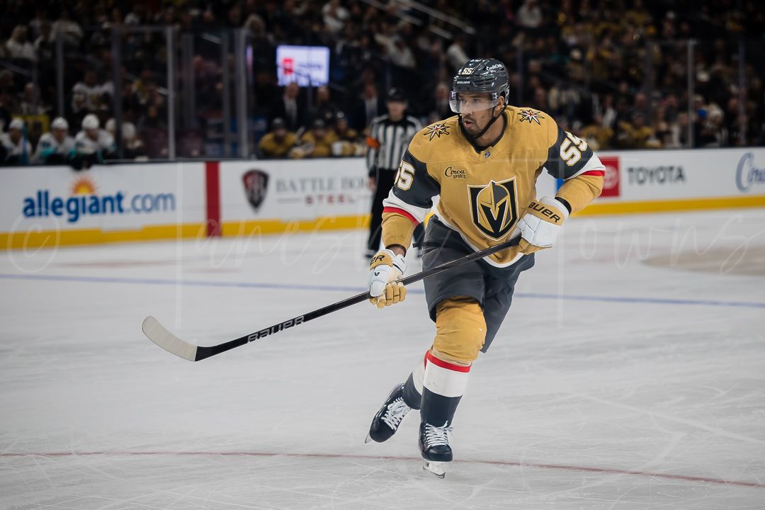 A Golden Knights player skates with the puck during an NHL game.