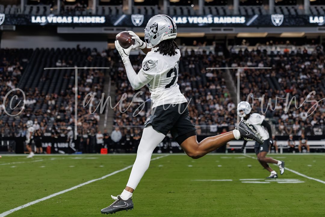 Las Vegas Raiders player catches a pass during warm-ups at Allegiant Stadium.
