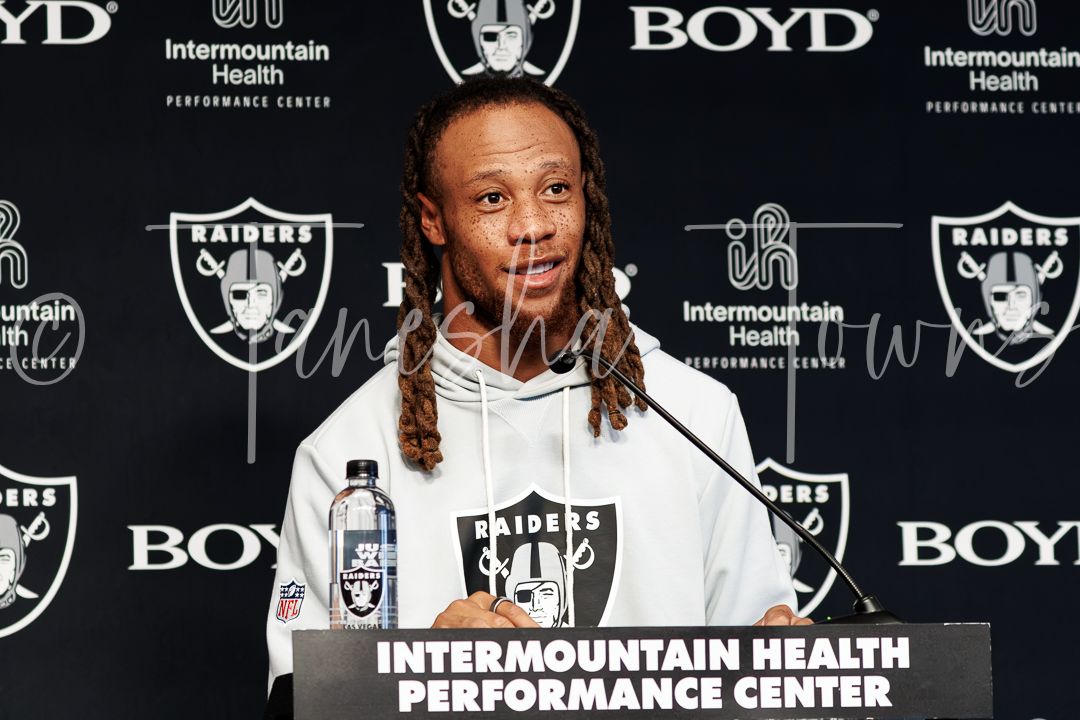 Raiders player speaks at a press conference podium at the Intermountain Health Performance Center.