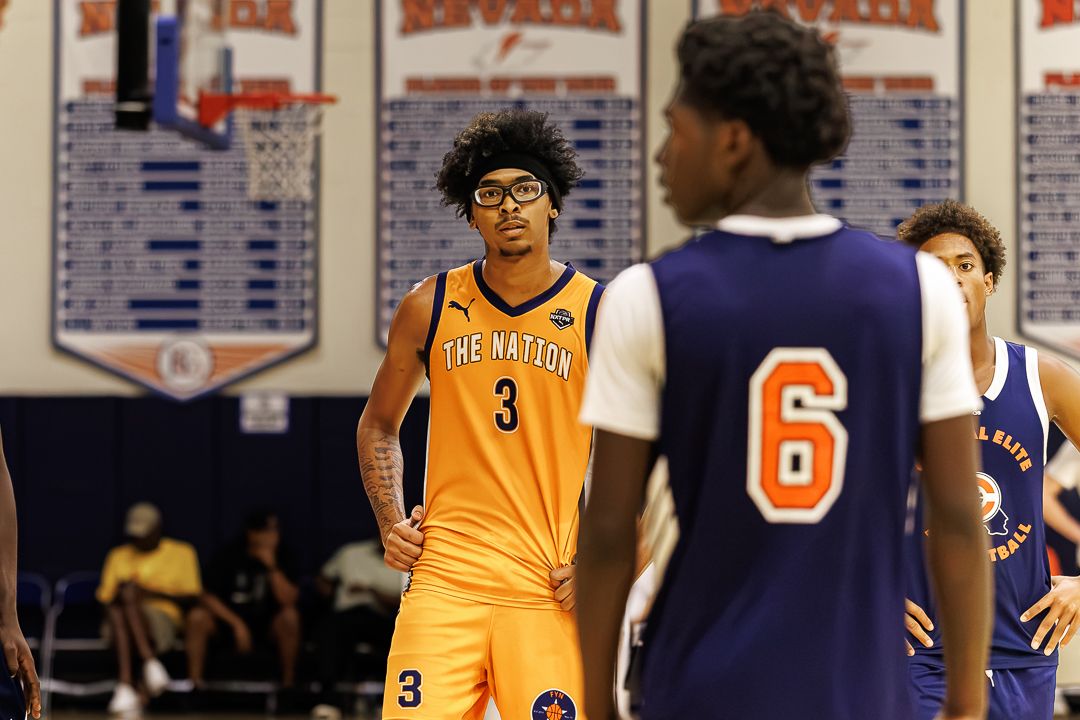 Basketball player wearing number 3 jersey for The Nation team stands on indoor court during youth basketball game.