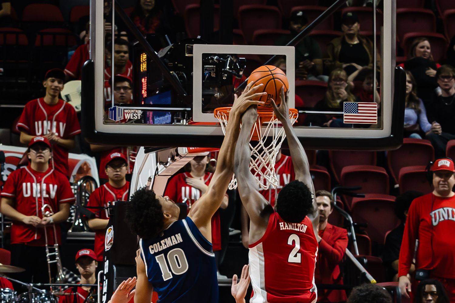 UNLV basketball players compete for a rebound during an intense college basketball game at the Thomas & Mack Center.
