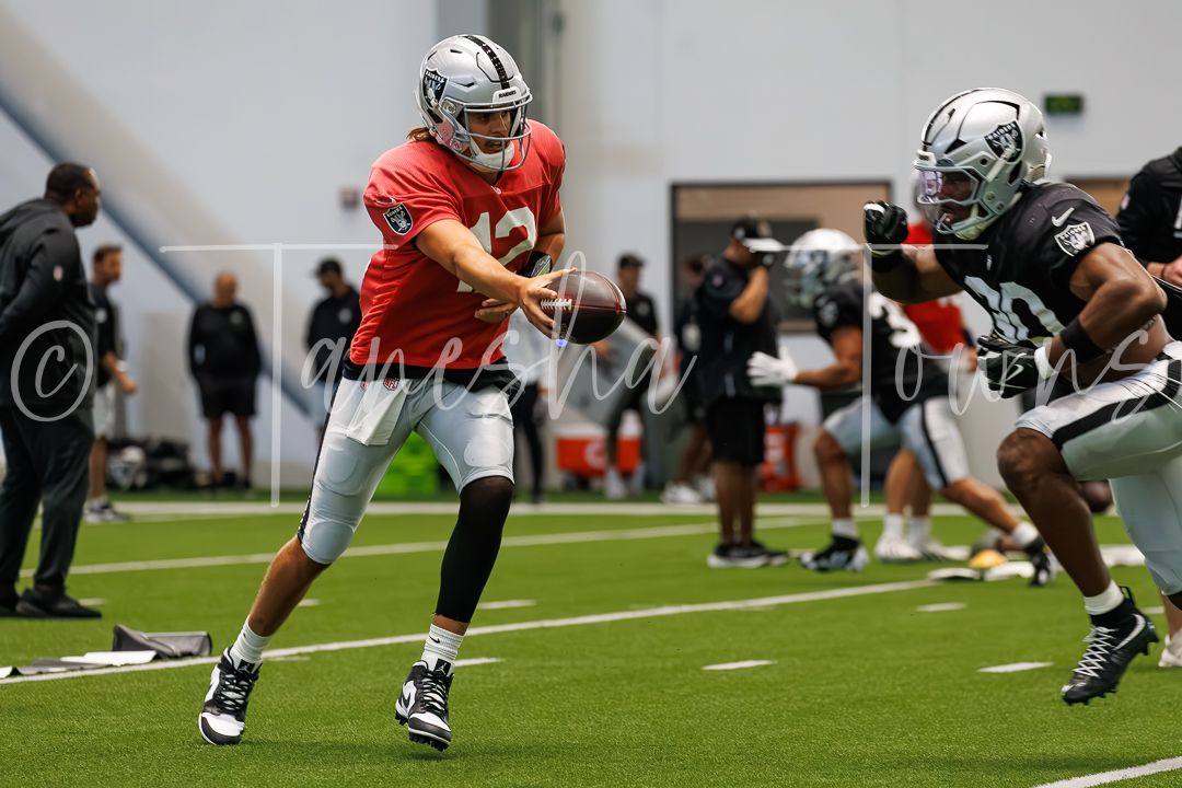 Raiders quarterback hands off the ball during an indoor practice drill at the Intermountain Health Performance Center.