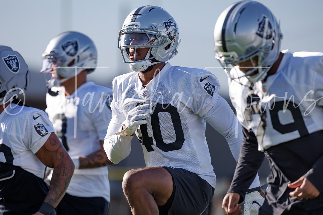 Las Vegas Raiders player wearing number 10 jersey runs drills during NFL training camp practice.