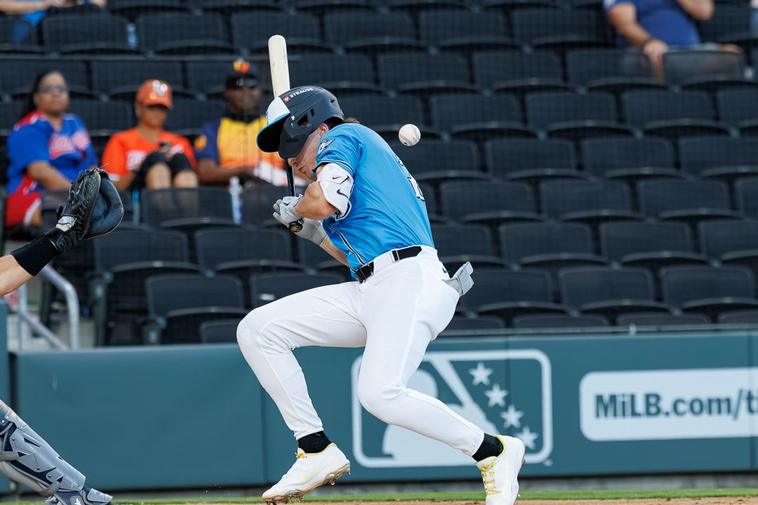 Baseball batter swings at a pitch during a MiLB game.