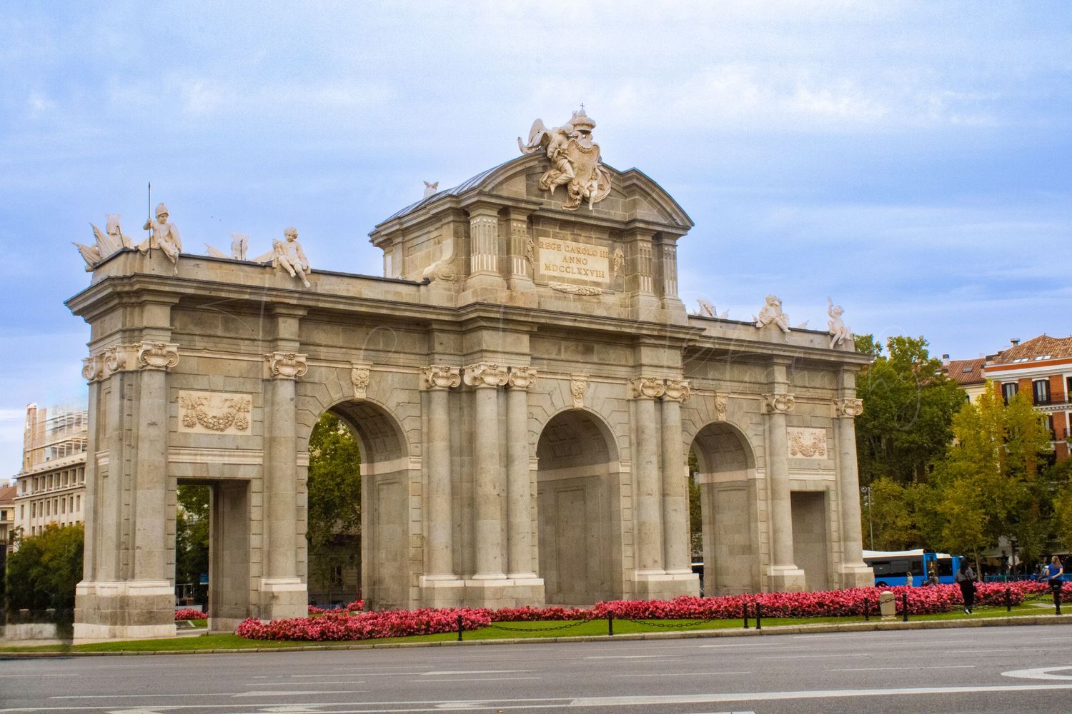Historic stone gate entrance with ornate architectural details stretching across frame.