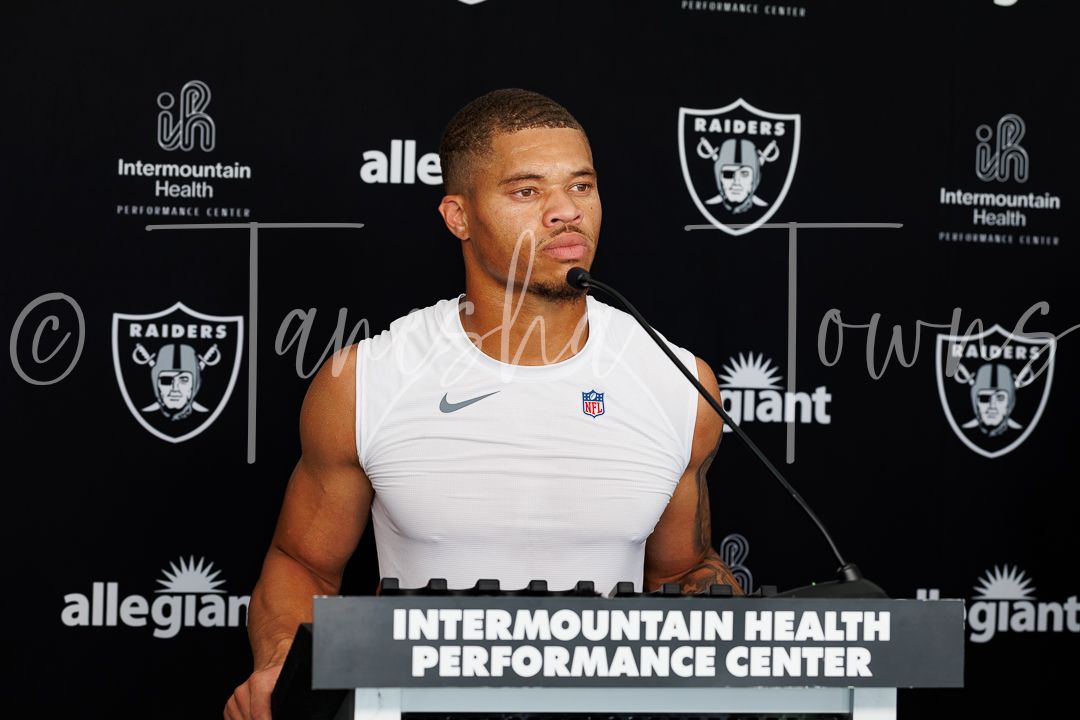 Las Vegas Raiders player speaks at Intermountain Health Performance Center podium.