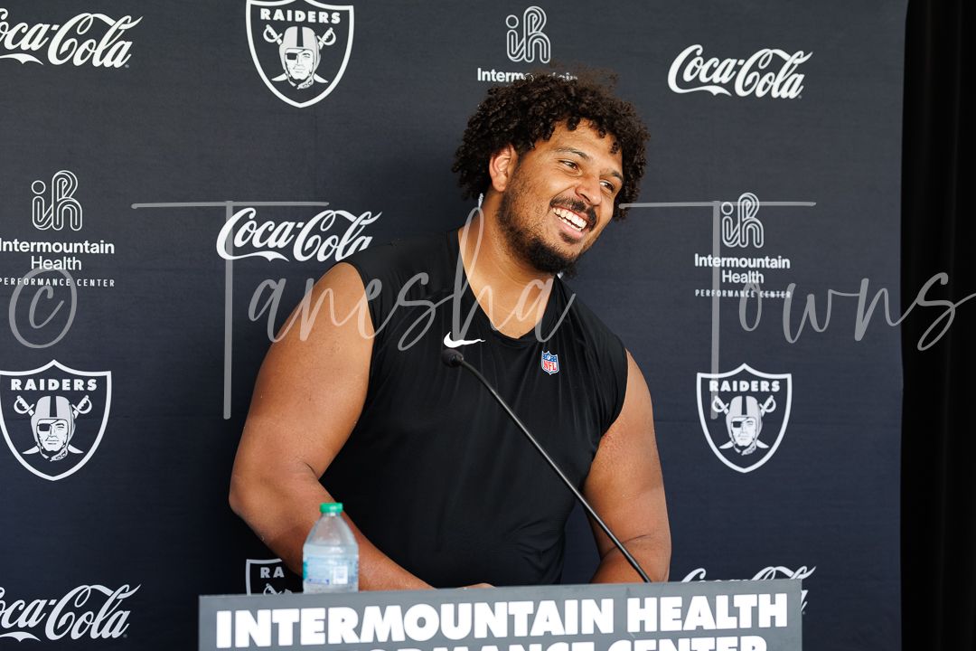 NFL Raiders player smiles during media session at Intermountain Health Performance Center.