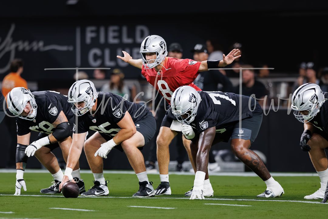 Las Vegas Raiders quarterback leads offensive line drill during NFL training camp practice at Allegiant Stadium.