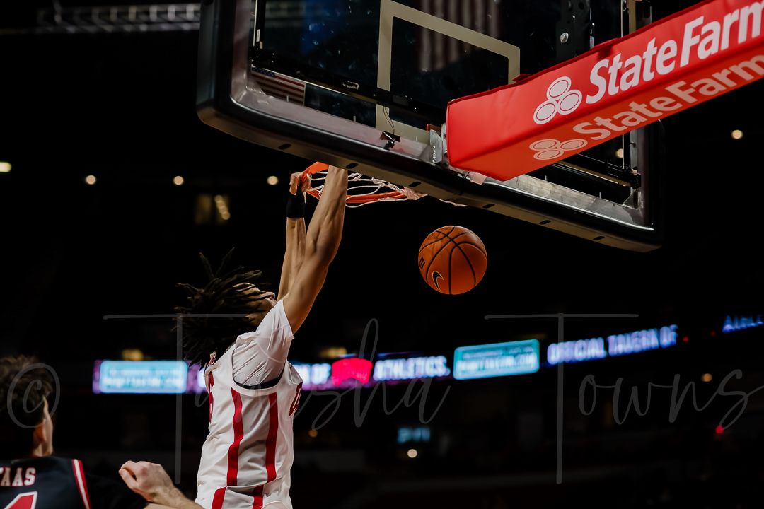 Basketball arena with State Farm signage visible above the court during a game.