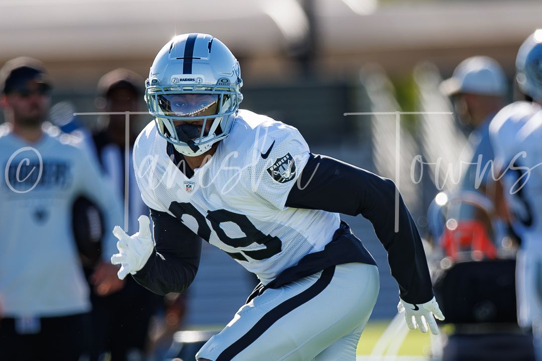 Las Vegas Raiders player number 29 runs a drill in white uniform during NFL training camp practice.