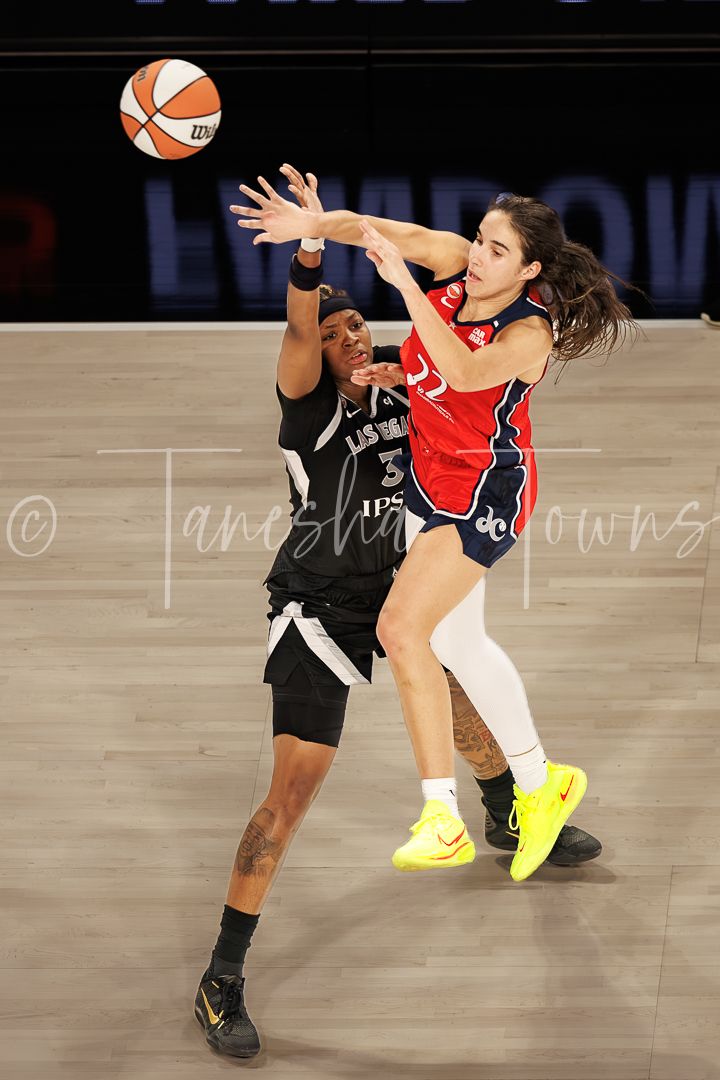 Las Vegas Aces defender contests a pass by Washington Mystics guard during a WNBA game.