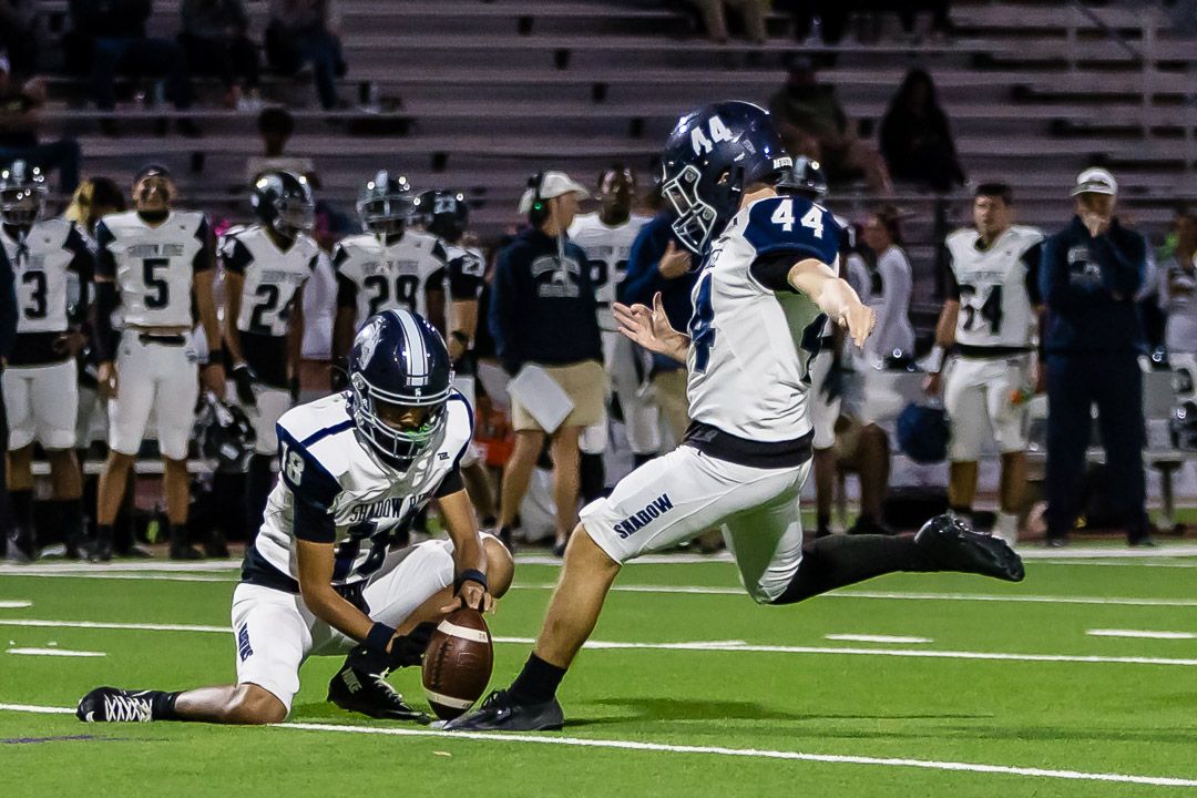 Football players scramble for the ball during an intense play on the field.