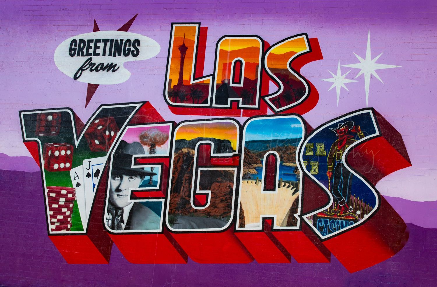 Colorful graffiti art mural with text and designs in purple and red tones spans across a wall.
