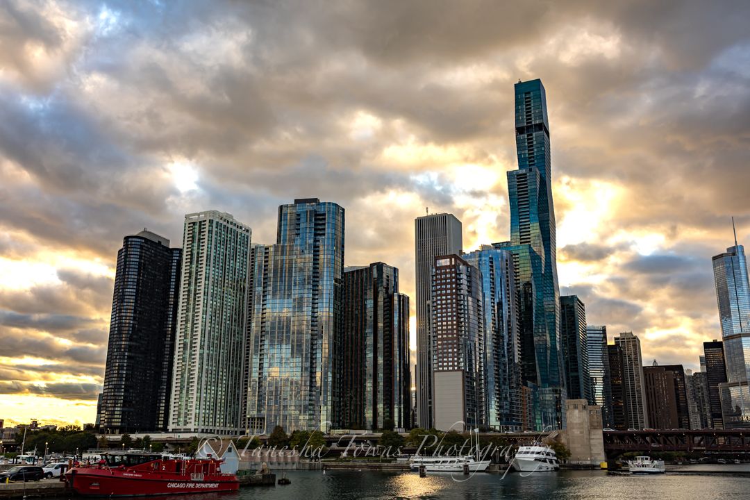 Sweeping cityscape of downtown Seattle's waterfront with dramatic sunset clouds and towering buildings.