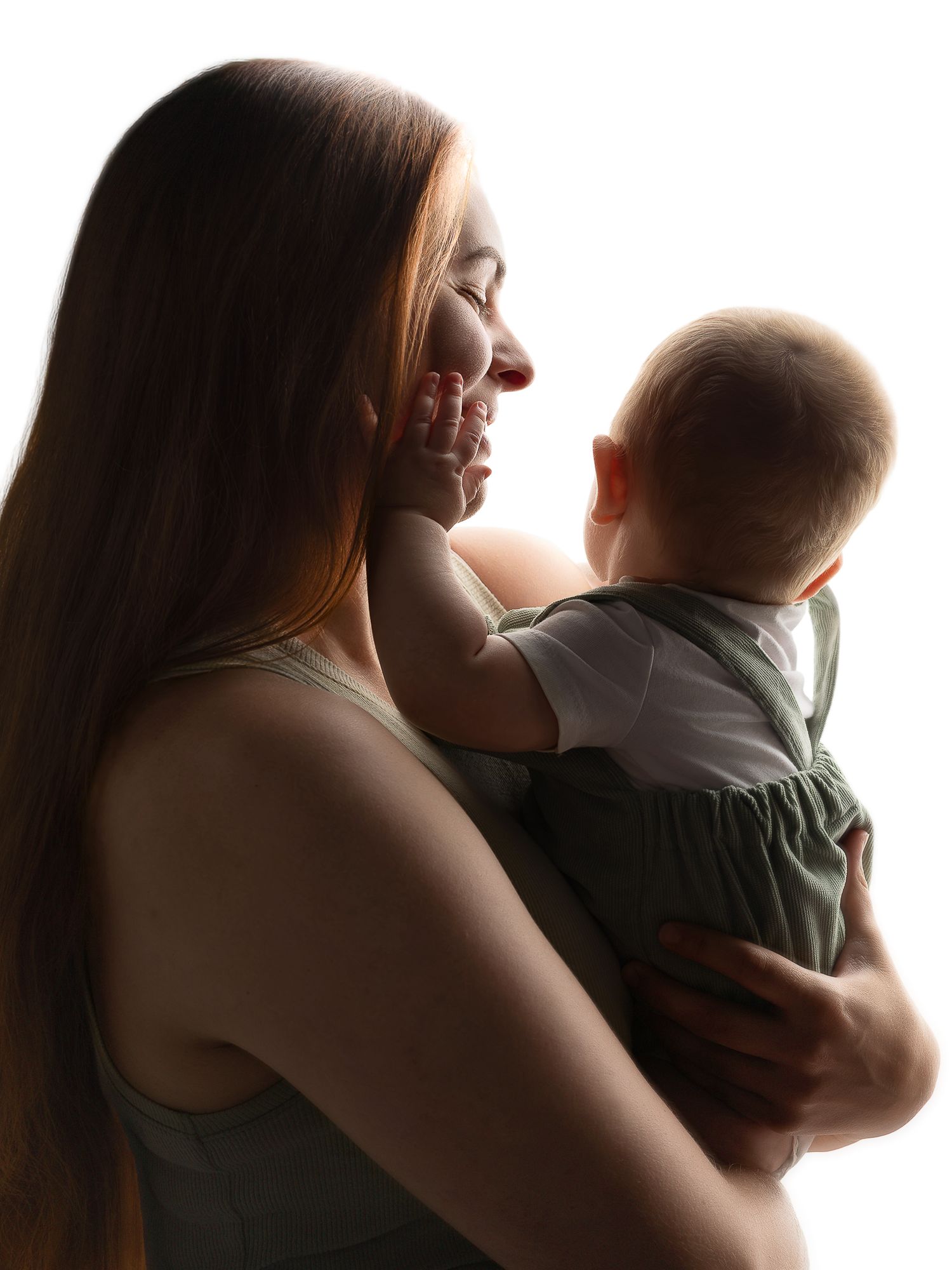 A young mother tenderly holds her smiling baby against a bright white background in a heartwarming portrait.