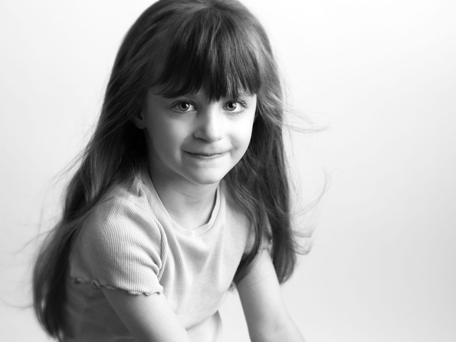 Portrait series shows child with flowing hair against white background.