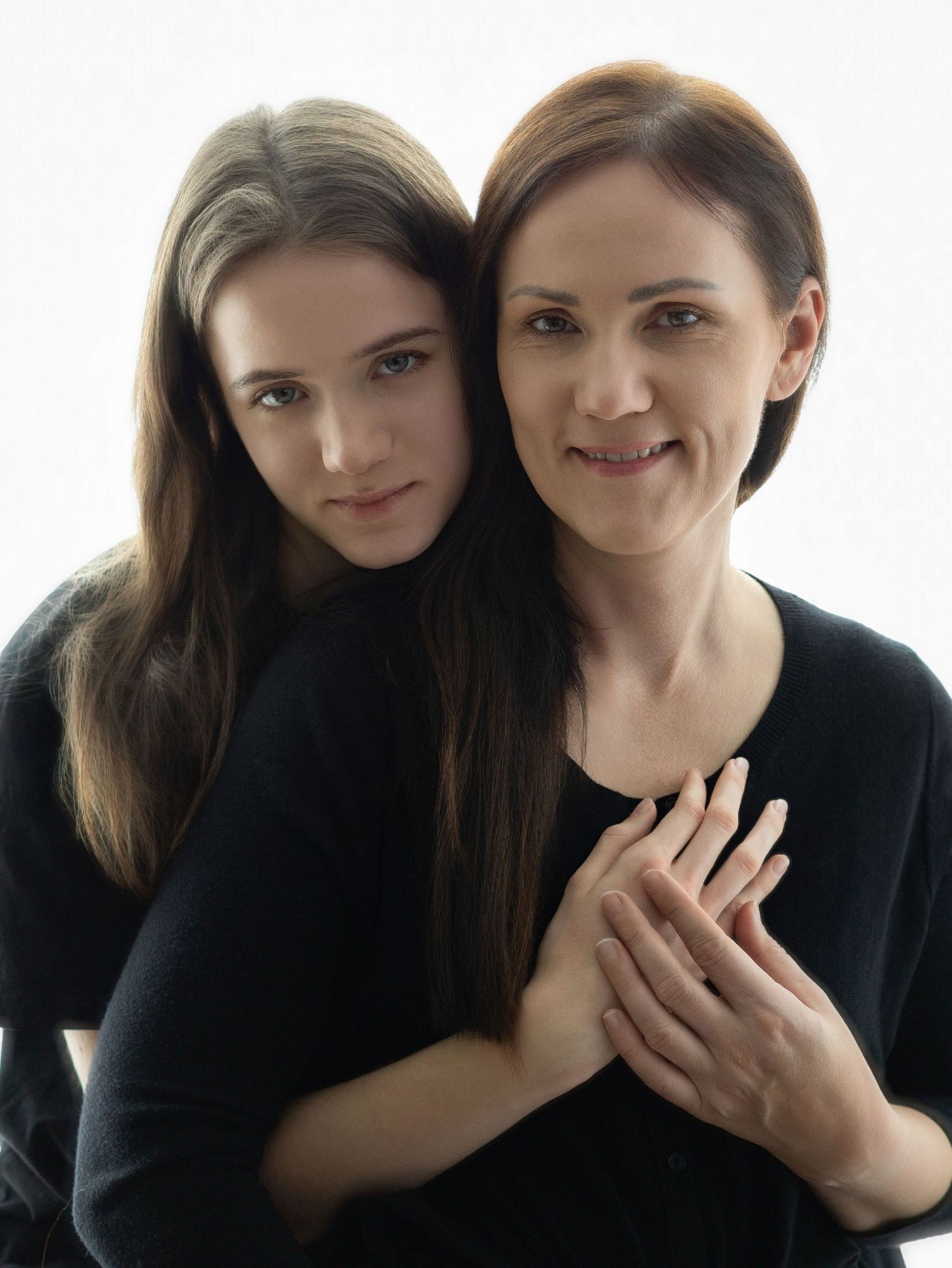 A series of five black and white portraits showing two people posing together with playful expressions.