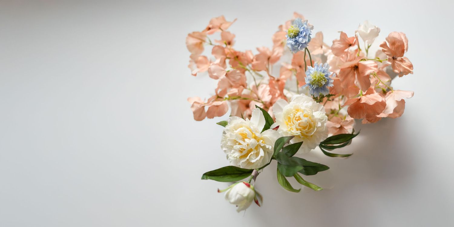 Pink and white floral bouquet arrangement displayed in a sequence showing different stages of assembly.