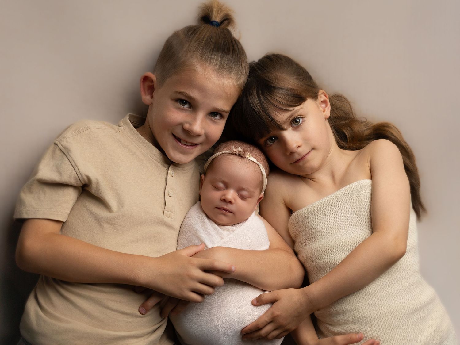 Family portrait series showing tender moments in neutral tones.