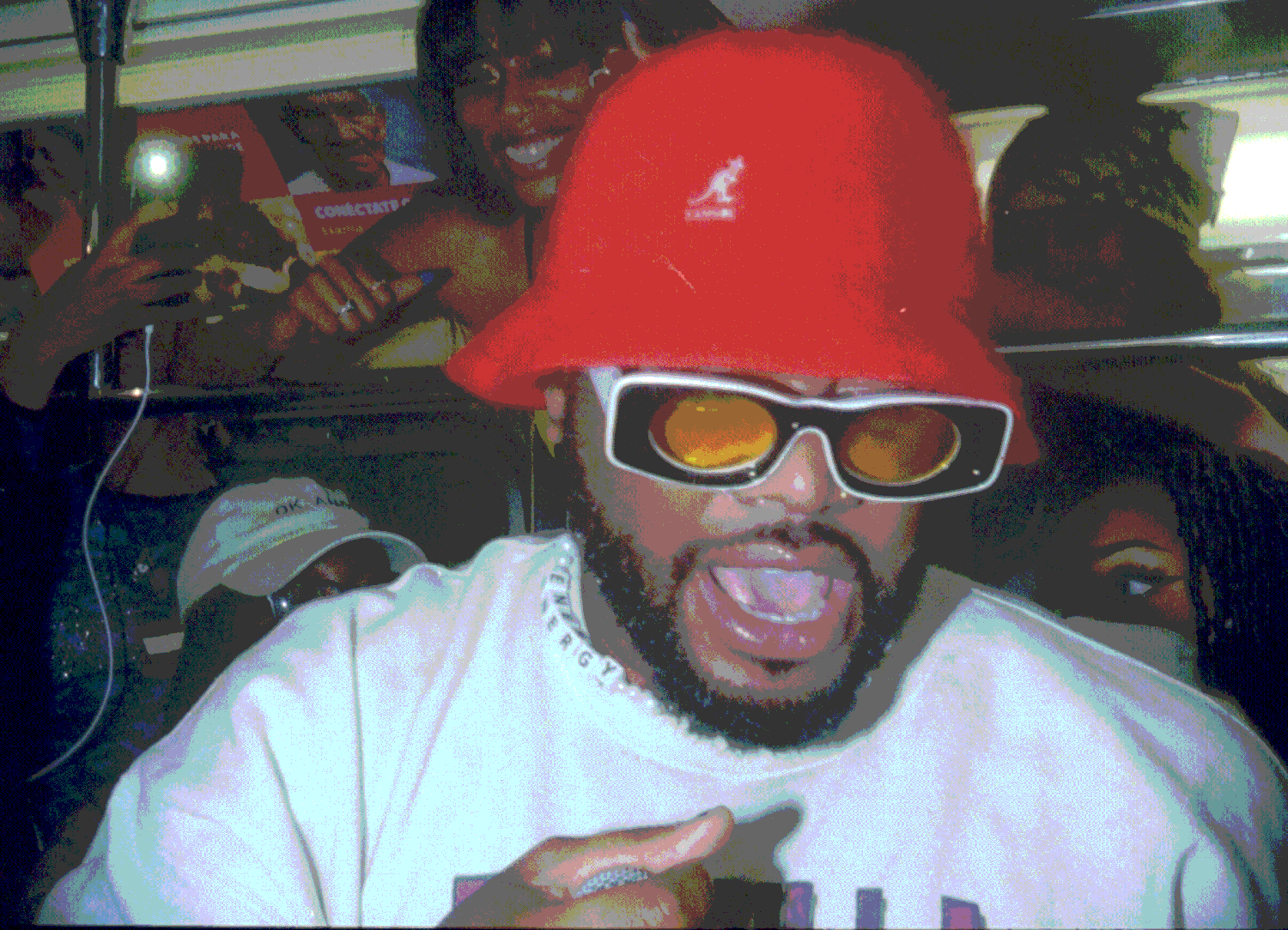 man holding microphone in red hat on nyc sybway train performing