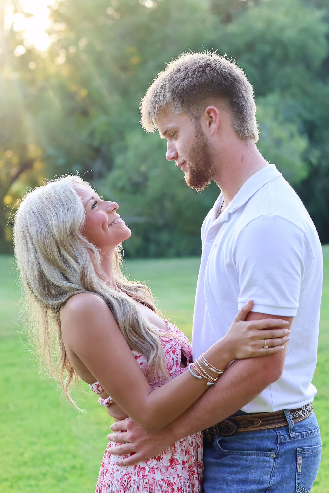 A couple embraces outdoors in a romantic sequence of photos with a natural green background.