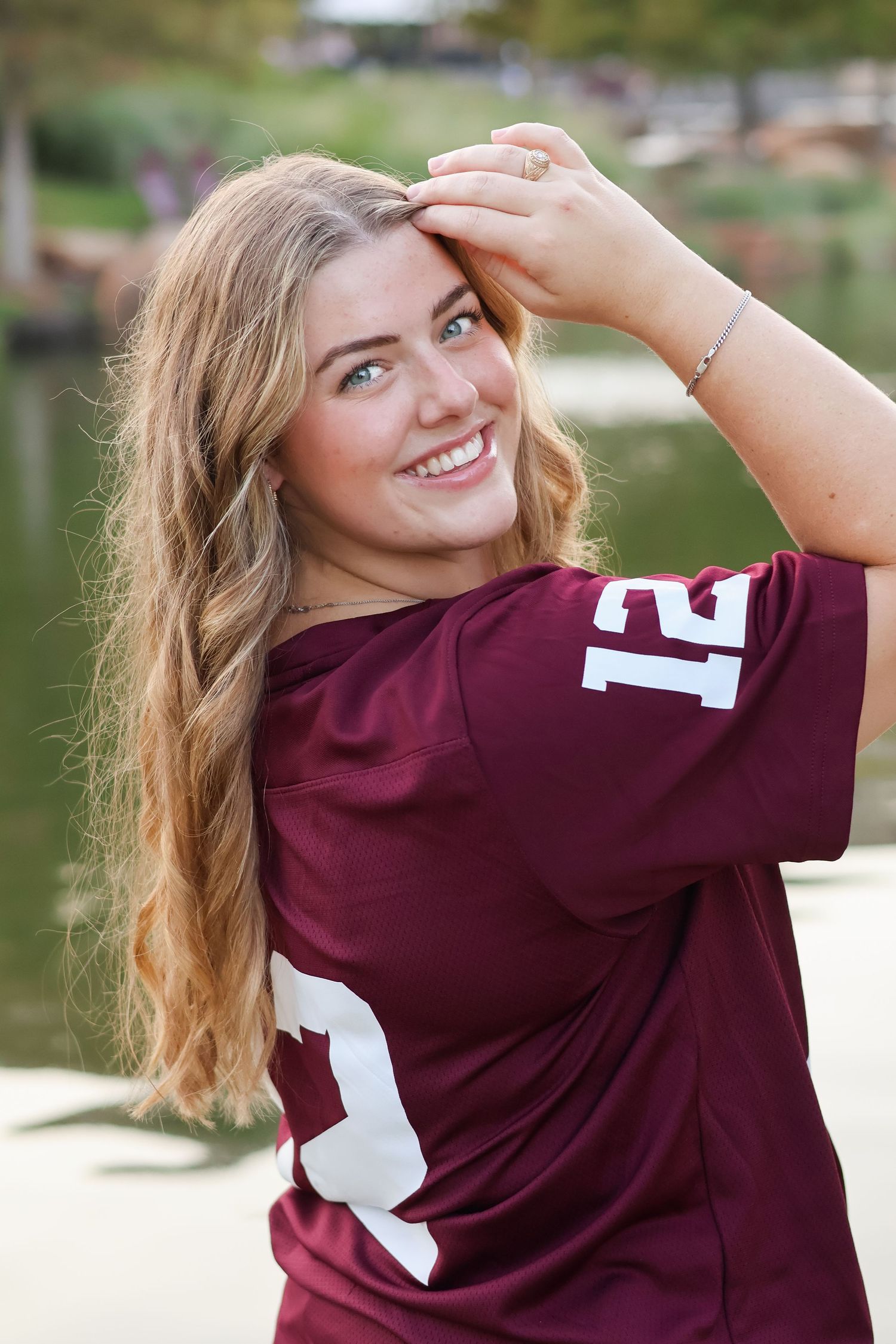 Person wearing maroon sports jersey with number 12 poses outdoors in a series of casual shots.