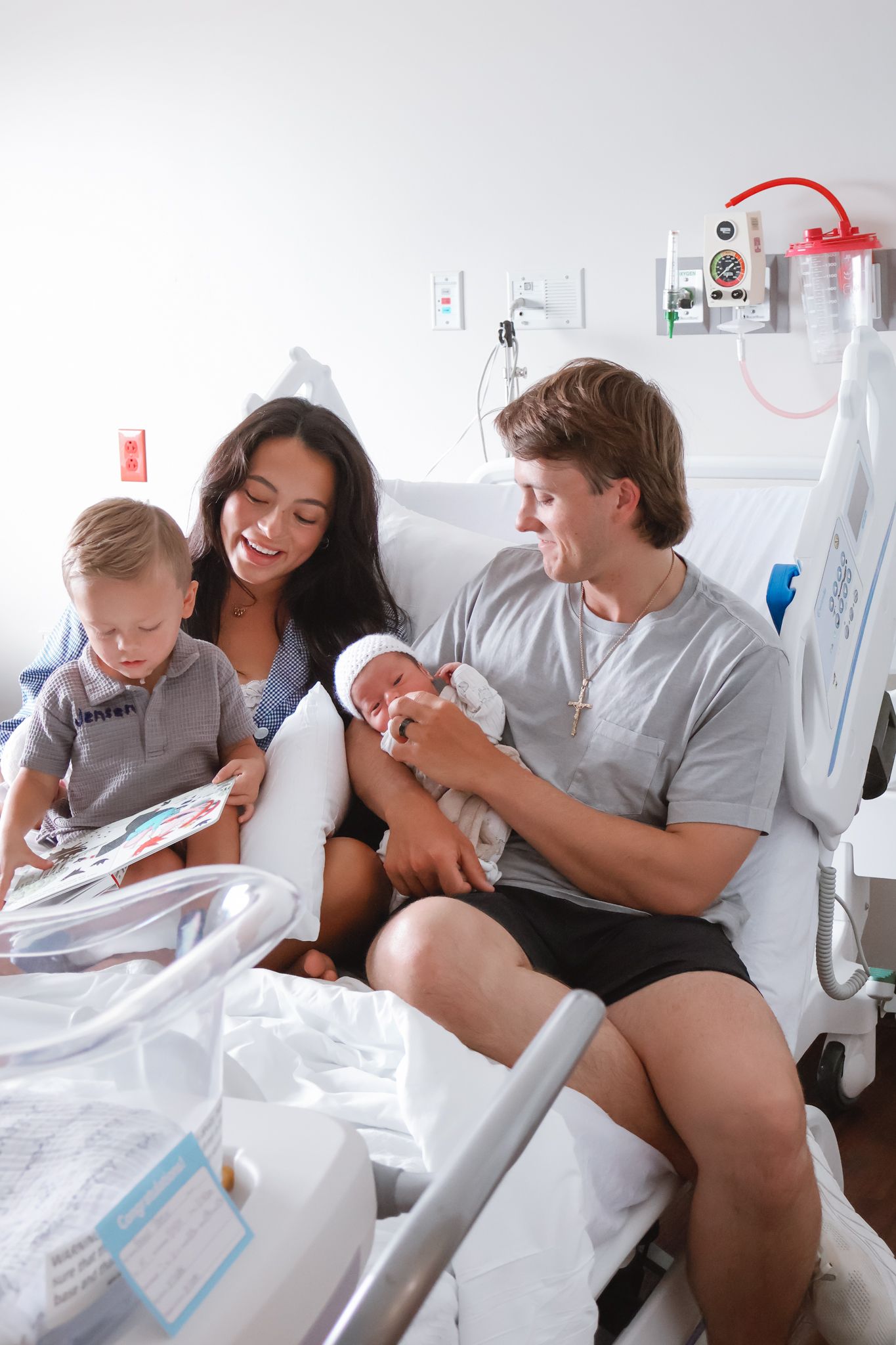 Family gathered together during medical treatment session in hospital room.