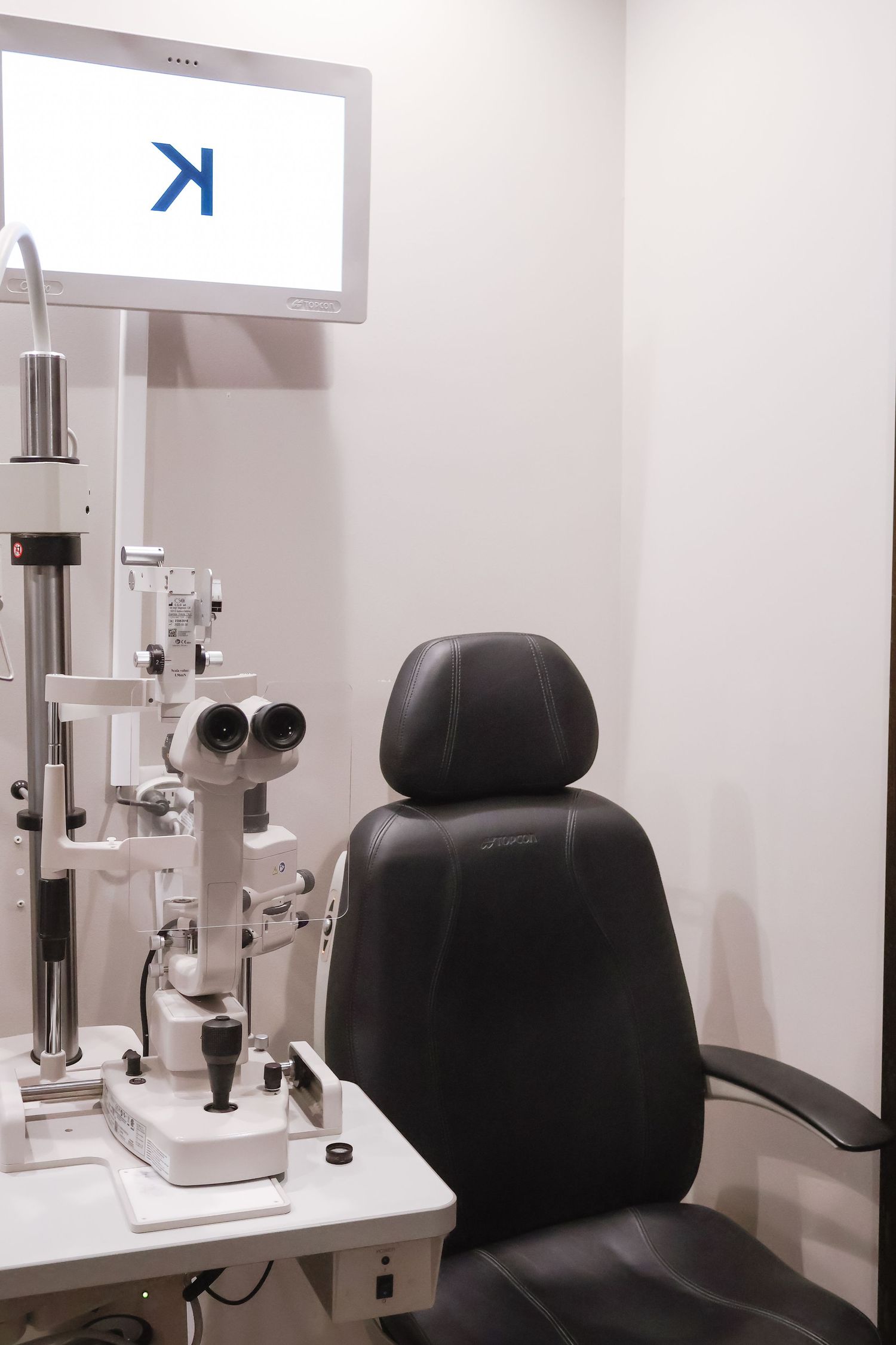 Modern optometry examination room with professional eye testing equipment.